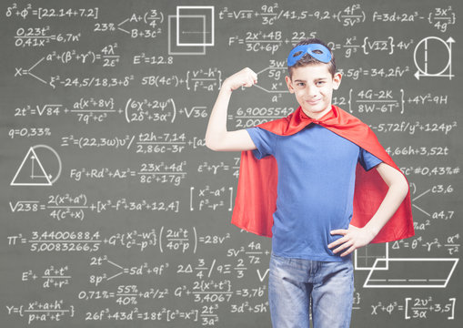 Education concept with confident super hero boy in front of a blackboard