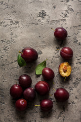 plums on stone background