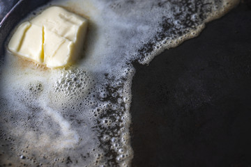 Butter in an pan. On rustic background.