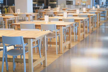 Interior of wooden table in food court shopping mall. Food center in department store.