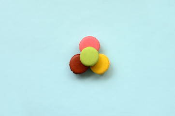 Dessert cake macaron or macaroon on trendy pastel blue background top view. Flat lay composition