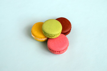 Dessert cake macaron or macaroon on trendy pastel blue background. Fashionable tasty colorful cookies