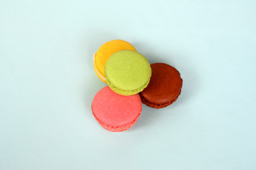 Dessert cake macaron or macaroon on trendy pastel blue background. Fashionable tasty colorful...