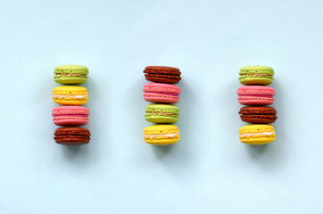 Dessert cake macaron or macaroon on trendy pastel blue background top view. Flat lay composition
