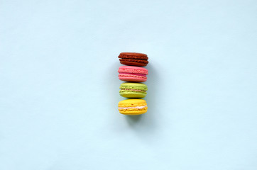 Dessert cake macaron or macaroon on trendy pastel blue background top view. Flat lay composition