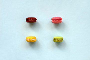 Dessert cake macaron or macaroon on trendy pastel blue background top view. Flat lay composition