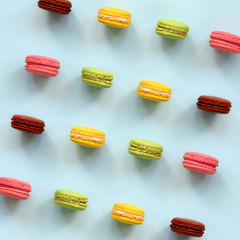 Dessert cake macaron or macaroon on trendy pastel blue background top view. Flat lay composition