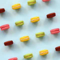 Dessert cake macaron or macaroon on trendy pastel blue background top view. Flat lay composition
