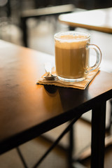Hot coffee on a wooden background with vintage style concept.