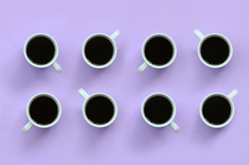Many small white coffee cups on texture background of fashion pastel violet color paper in minimal concept