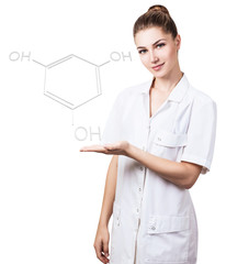 Young female doctor presents chemical formula.