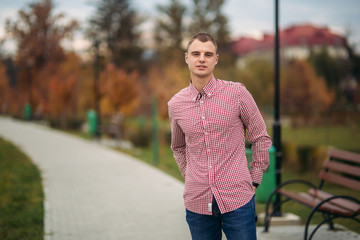 Young guy in red shirt stay in the park