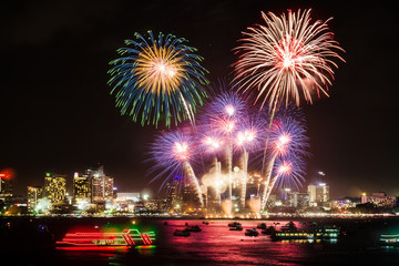 Fototapeta premium festive colorful firework light up the sky over the city at night scene for holiday festival and celebration background