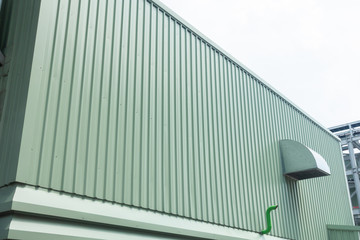 Green metal sheet siding of building and ventilate