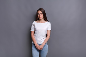 Shy pensive young woman studio shot