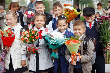 A group of schoolgirls with flowers.