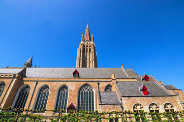 A spring day view of the beautiful, medieval Church of Our Lady in Bruges (dutch: Brugge), Belgium. Selective focus with wide angle lens