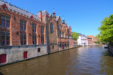 Fototapeta premium Beautiful view of the canal and traditional houses in the old town of Bruges (dutch: Brugge), Belgium. Spring landscape photo