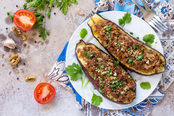 Classic baked eggplant with meat, walnut and vegetables. Traditional middle eastern or arab dish. Flat flay, top view with copy space.