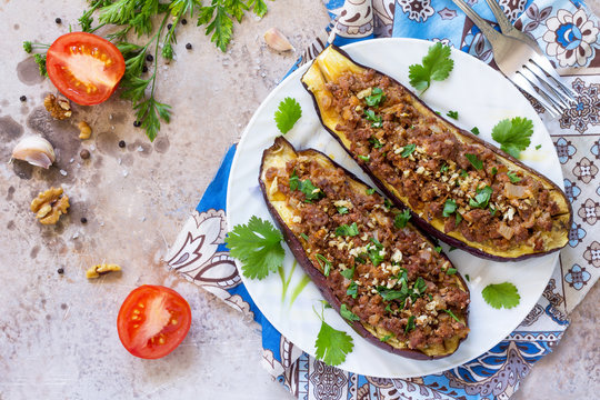 Classic baked eggplant with meat, walnut and vegetables. Traditional middle eastern or arab dish. Flat flay, top view with copy space.