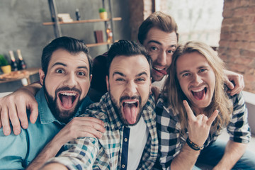Self portrait of four attractive comic crazy funny foolish guys with hairstyle, showing tongue out...