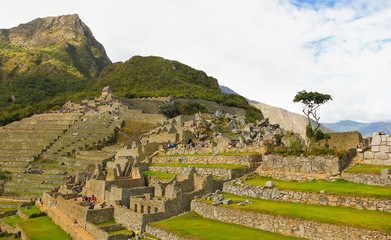 Fototapeta na wymiar Splendid views of Machu Picchu ruins with many tourists walking around, Peru. Unesco World Heritage Site, travel destination