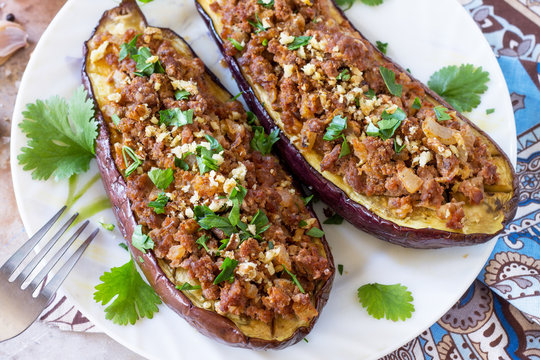 Classic baked eggplant close-up with meat, walnut and vegetables. Traditional middle eastern or arab dish.