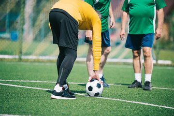 partial view of old men playing football together on field