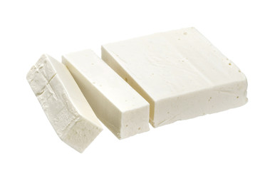Greek feta. Sliced white cheese isolated on white background
