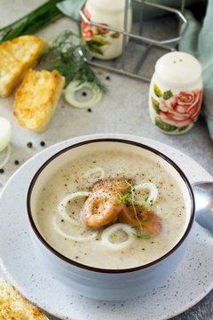 Diet menu. Puree soup mushrooms with croutons in a bowl on a light slate background. The concept of healthy eating.