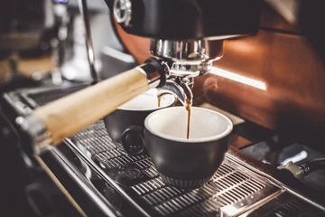 Foto auf Acrylglas Espresso poruing from coffee machine at cafe © leszekglasner