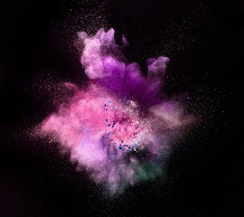 Colored powder explosion isolated on black background.