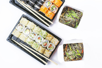 .Delivery of sushi and noodles for two. A white background.