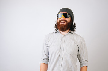 White bearded young man smiling, dreaming about camping, mountains, sport.