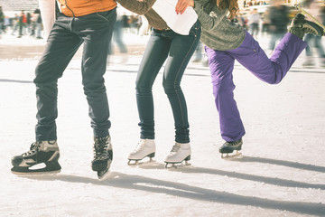 Funny teenagers girls and boy skating outdoor, ice rink - obrazy, fototapety, plakaty