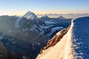 Beautiful sunrise on the mountains above clouds, Fann, Pamir Alay, Tajikistan