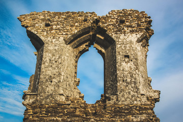 Old castle wall and window with blue sky background
