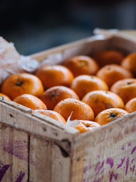 Wooden box with fresh oranges
