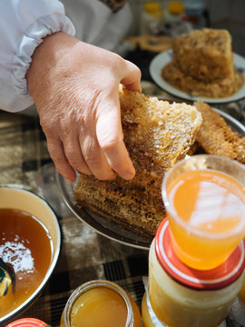 Crop beekeeper taking honey cell