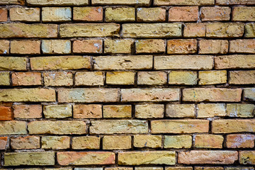 Brick wall of various yellow colors in modern loft interior