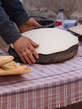 Crop woman rolling out pastry