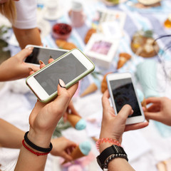 Hands with mobile phone shooting food