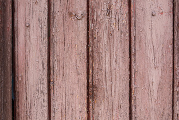 Old vertical pink wooden planks outdoors. Vintage rustic background texture.