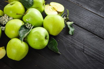 Ripe green apples on the green background