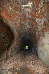 The Light at the End of the Tunnel. Abandoned Tarakaniv Fort in the summer day. Tarakaniv, Rivne oblast, Ukraine