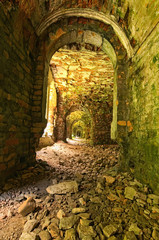 Very long corridor with many arches. Abandoned Tarakaniv Fort in the summer day. Tarakaniv, Rivne oblast, Ukraine
