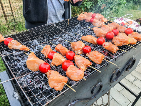 Barbecue of chicken meat with vegetables on the coals. Chicken skewers with grilled vegetables 
