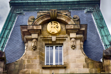 monogram of the house owner under the lush canopy of stone