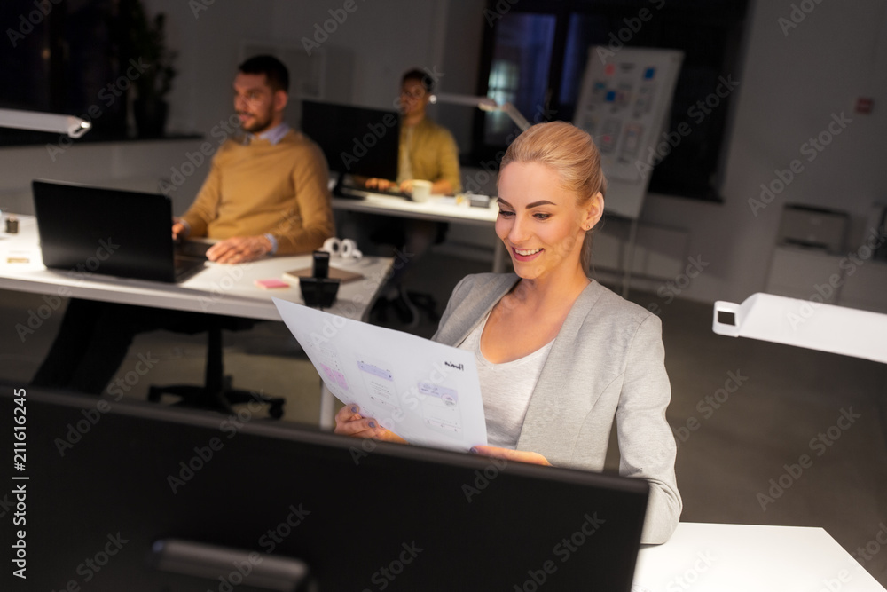 Poster business, deadline and technology concept - designer or user interface developer with papers working