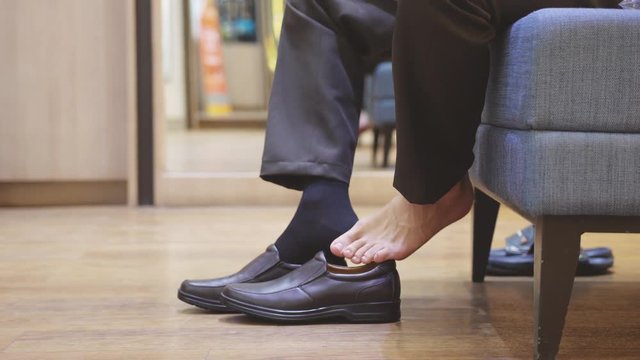 Businessman puts on brown new fashion shoes and socks. slow motion. 3840x2160